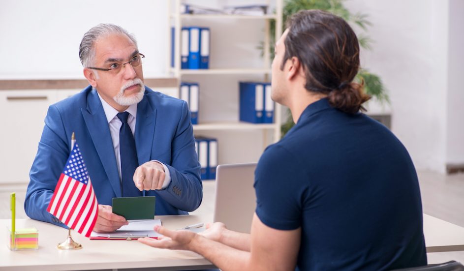 Young,Man,Visiting,Embassy,For,Visa,Application