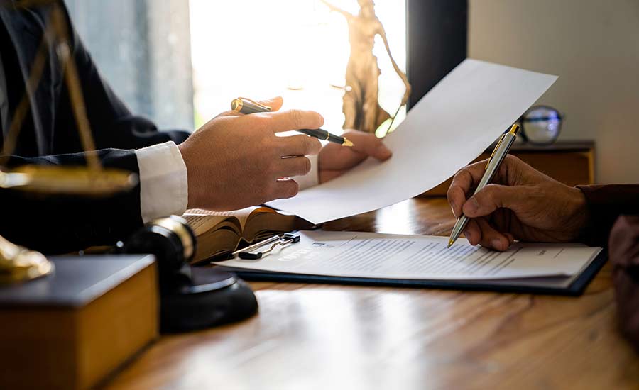 An attorney and a client discussing a car accident claim​