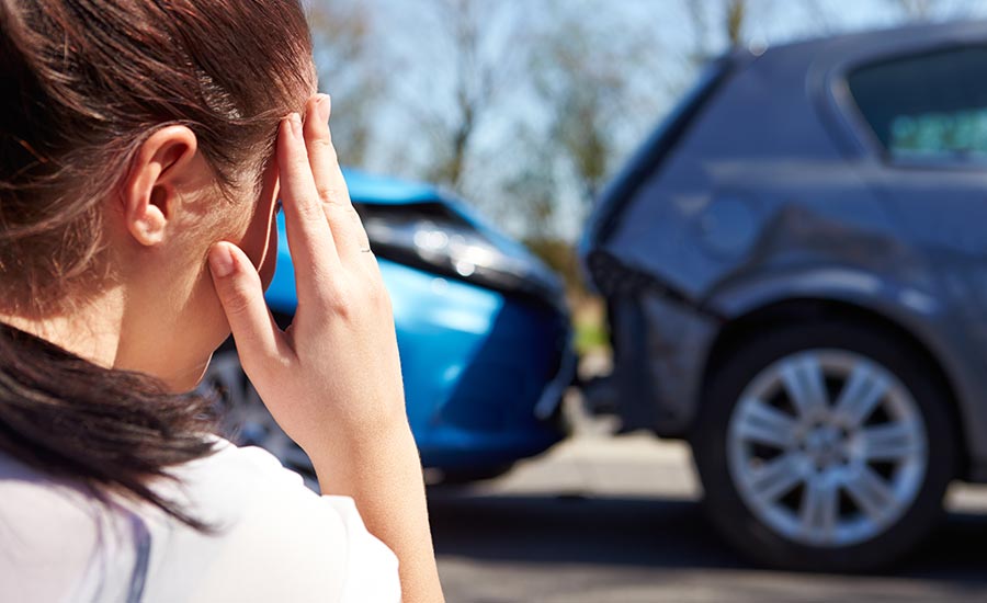 A stressed female driver after a car accident​