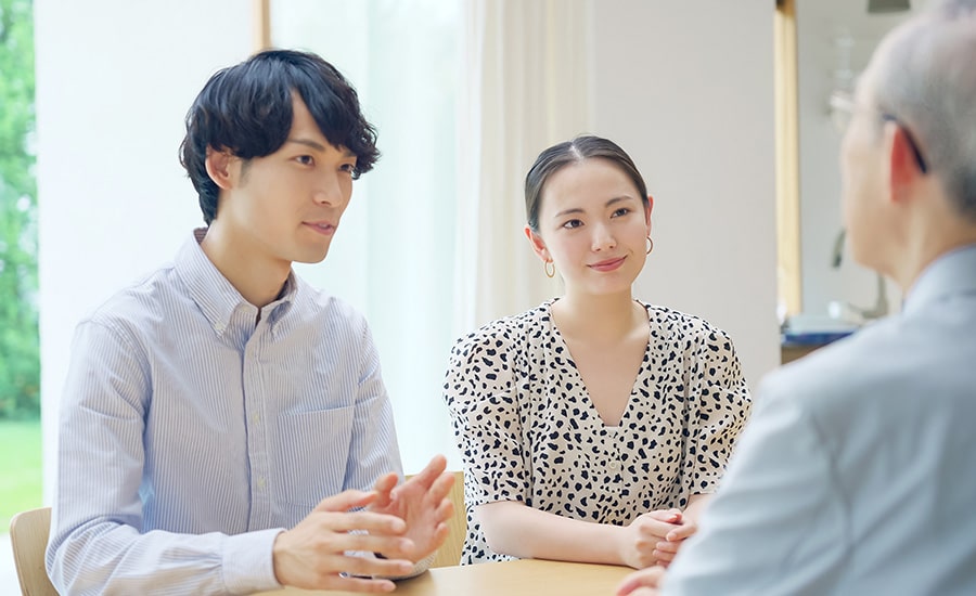 A couple attending a Green Card marriage interview