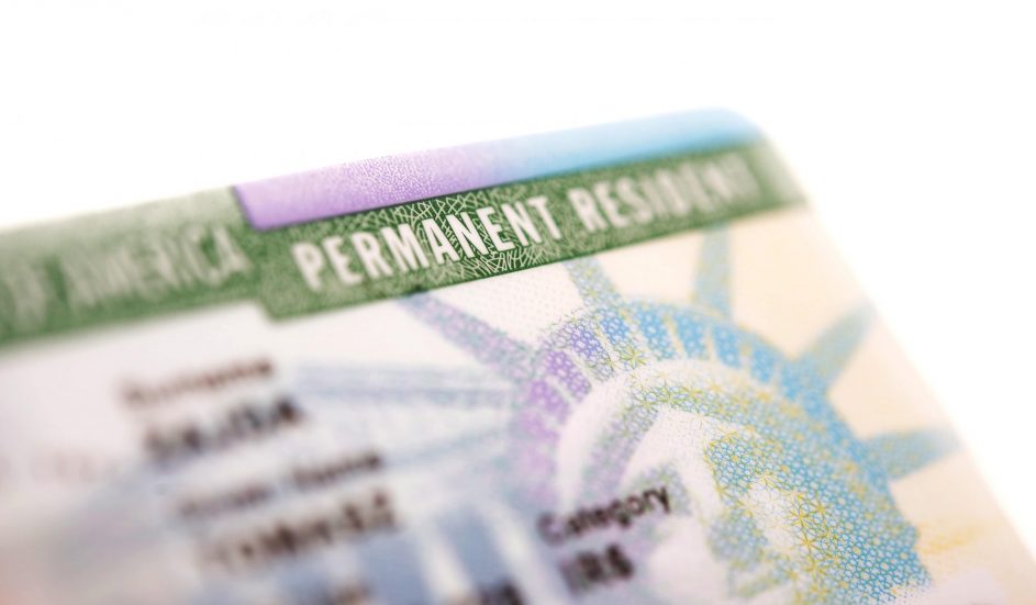 A person holding a Green Card