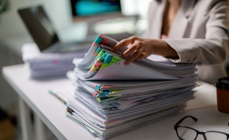 A female business owner with piles of documents